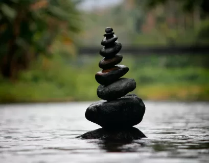 black stackable stone decor at the body of water